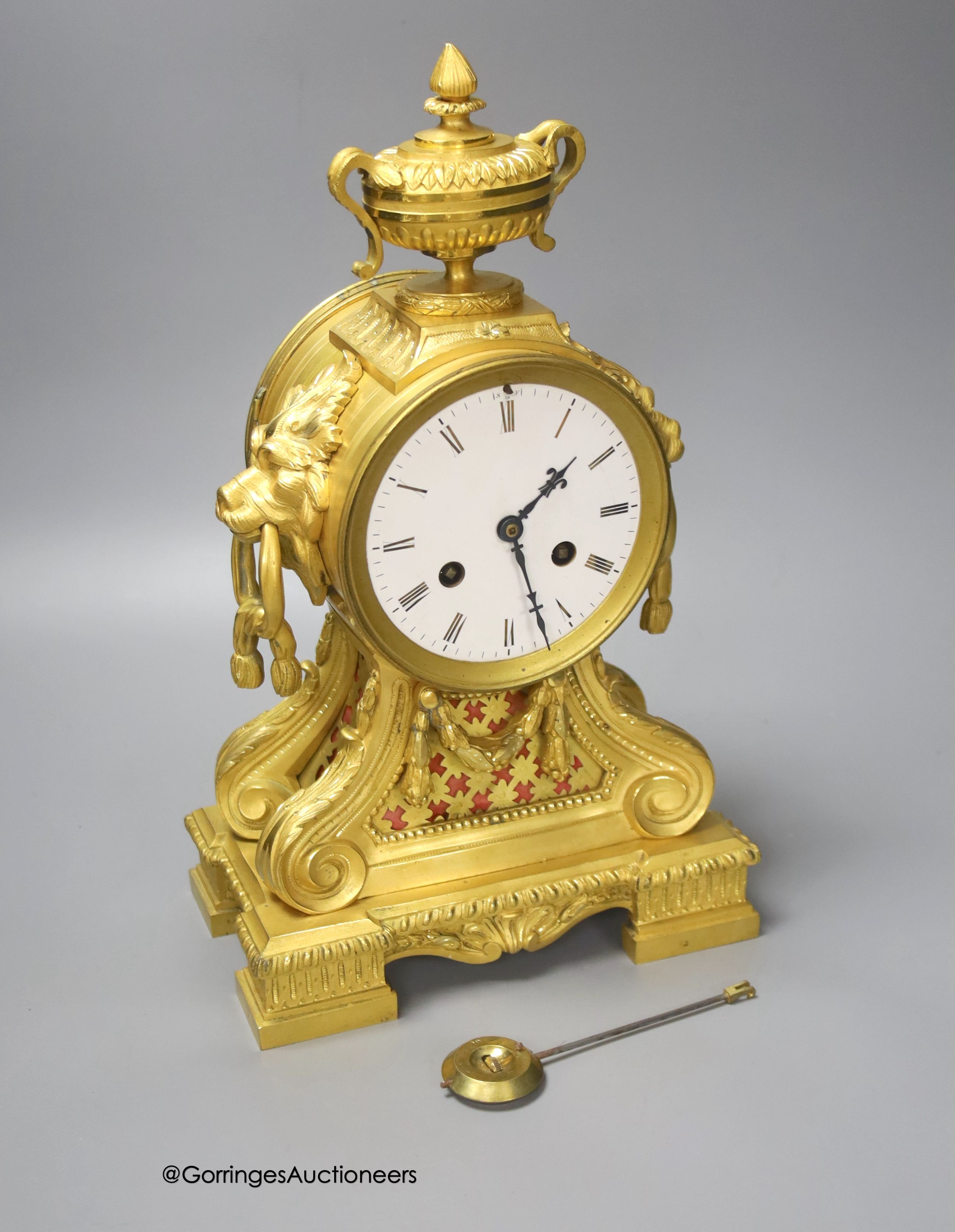 A 19th century French ormolu clock, with lion mask ring handles, 34cm